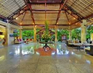 a lobby with a table in the middle of a building at Bali Agung Village - CHSE Certified in Seminyak