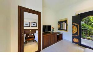 a room with a door leading to a bedroom at Bali Agung Village - CHSE Certified in Seminyak