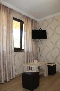 a living room with a table and a window at Emis Hotel in Tbilisi City