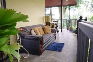 a living room with a couch on a balcony at City Breeze Residence in Kandy