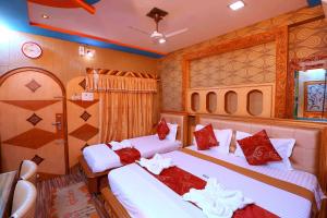 a room with two beds in a train at Hotel Shri Swarna's Palace - A Business Class Hotel in Tiruchchirāppalli