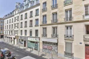 a large white building on a street with a street at 93 - Luxury Flat in Le Marais in Paris