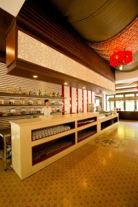 a person standing behind a counter in a restaurant at Seava Ho Tram Beach Resort in Ho Coc