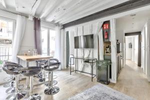 a living room with a table and bar stools at 93 - Luxury Flat in Le Marais in Paris