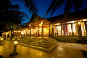 a building with stairs in front of it at night at Seava Ho Tram Beach Resort in Ho Coc