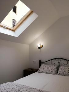 a bedroom with a bed and a skylight at BrasovApart Piata Sfatului 1 in Braşov