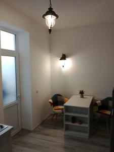 a room with a table and chairs and a window at BrasovApart Piata Sfatului 1 in Braşov +12 photos