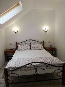 a bedroom with a bed with two nightstands and two lights at BrasovApart Piata Sfatului 1 in Braşov