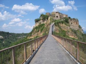 a bridge with a castle on top of a mountain at Civita B&B in Bagnoregio