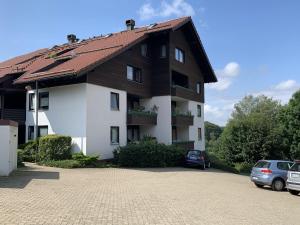a house with a car parked in front of it at Ferienwohnung Voges in Bad Lauterberg
