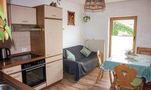a kitchen with a table and a small kitchen with a small table and a table at Ferienwohnung Dichtl in Grafenau