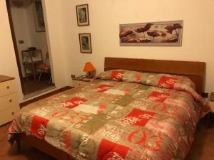 a bedroom with a bed with a quilt on it at Great Sicily in Mondello