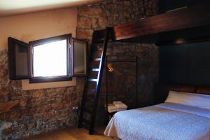 A bed or beds in a room at Casa Plaza de Culla