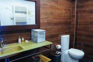 a bathroom with a toilet and a sink and a mirror at Casa Plaza de Culla in Culla