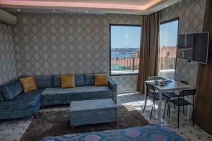 a living room with a couch and a table at ROYAL TAKSIM SUITES in Istanbul