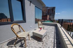 a patio with two chairs and a table on a balcony at ROYAL TAKSIM SUITES in Istanbul