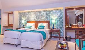 a hotel room with a bed and a desk at Adaaran Select Huduran Fushi - Premium All Inclusive in North Male Atoll