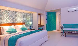 a hotel room with two beds and two lamps at Adaaran Select Huduran Fushi - Premium All Inclusive in North Male Atoll