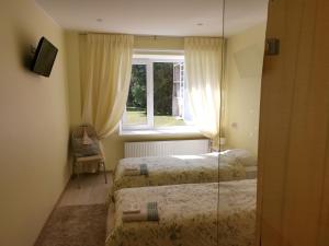 Postel nebo postele na pokoji v ubytování Ravila Manor