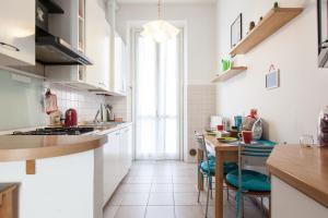 a kitchen with a table and chairs and a dining room at Milanofiere Flat in Milan