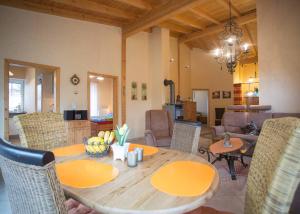 a dining room with a wooden table and chairs at Ferienwohnung Haus Edelweiss in Winterberg
