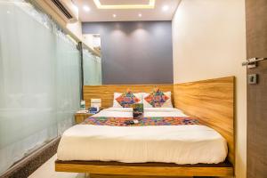 a bedroom with a bed in a room at FabExpress Marol Metro Andheri East in Mumbai