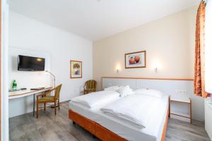 Postel nebo postele na pokoji v ubytování Hotel Stadtkrug