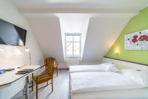 Postel nebo postele na pokoji v ubytování Hotel Stadtkrug