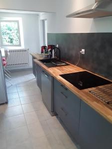 a kitchen with a sink and a counter top at La villa in Le Vigan