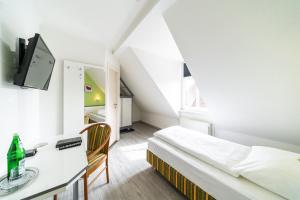 Postel nebo postele na pokoji v ubytování Hotel Stadtkrug