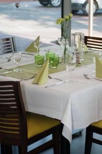 a table with a white tablecloth and glasses on it at Fehren einfach gut in Lingen