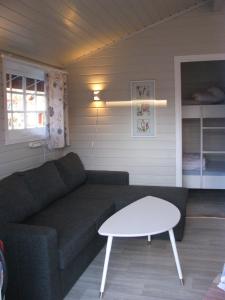 a living room with a couch and a table at Bergen Camping Park in Bergen