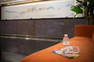 a table with a bottle of water sitting on a table at V Hotel Lavender in Singapore