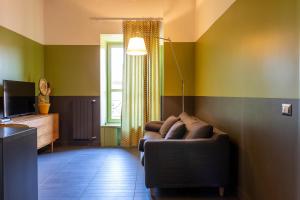 - un salon avec un canapé et une fenêtre dans l'établissement MODO Rooms & Suite Rome, à Rome