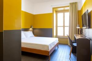Gulta vai gultas numurā naktsmītnē MODO Rooms & Suite Rome
