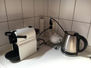 a kitchen counter with a toaster and a tea kettle at Bed & Office 050 in Groningen