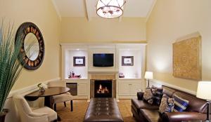 a living room with a couch and a fireplace at Carriage House Inn in Carmel