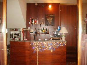 a bar with a counter with flowers on it at Grappoloduva B&B in Solopaca