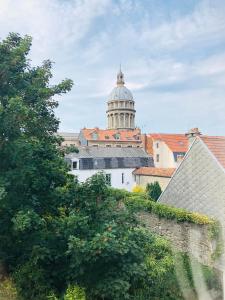 a view of a building with a cathedral in the background at Face aux remparts in Boulogne-sur-Mer +10 photos