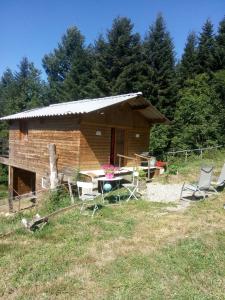 ein Haus mit einem Tisch und Stühlen davor in der Unterkunft Cabane in Mayres