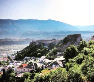 a view of a town with a castle on a hill at Stone rooms 1850 in Gjirokastër