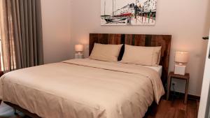 a bedroom with a large bed with two lamps at Les Pins de l'Escalet in Ramatuelle