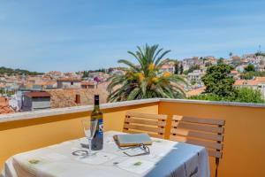 a bottle of wine sitting on a table with a view at apartman Nataša in Mali Lošinj