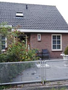 a house with a fence in front of it at Dendolili room in Amsterdam