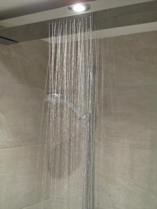 a shower with water hanging from the ceiling at Piglets Boutique Country Stay - winner Best B&B and Guest House of the Year - VisitEngland 2023 in Saffron Walden