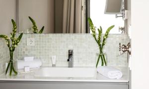 a bathroom with a sink and a mirror at Hotel Sylter Zollhaus in Westerland