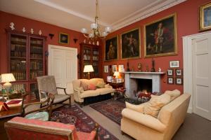 a living room with red walls and a fireplace at Crookston House B&B 