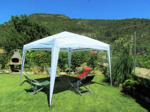 two chairs under a white tent in a yard at Casa Rural el Rincón in Perarrua +34 photos