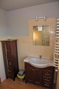 a bathroom with a sink and a mirror at Jankówka in Wieliczka