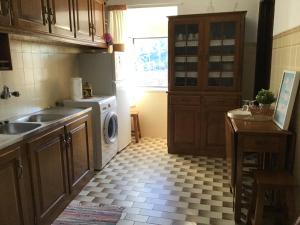 a kitchen with a sink and a washing machine at Casa Cardinho - A sua casa no Alentejo in Castelo de Vide